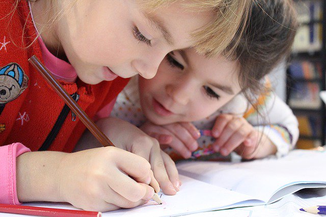 children writing in notebook