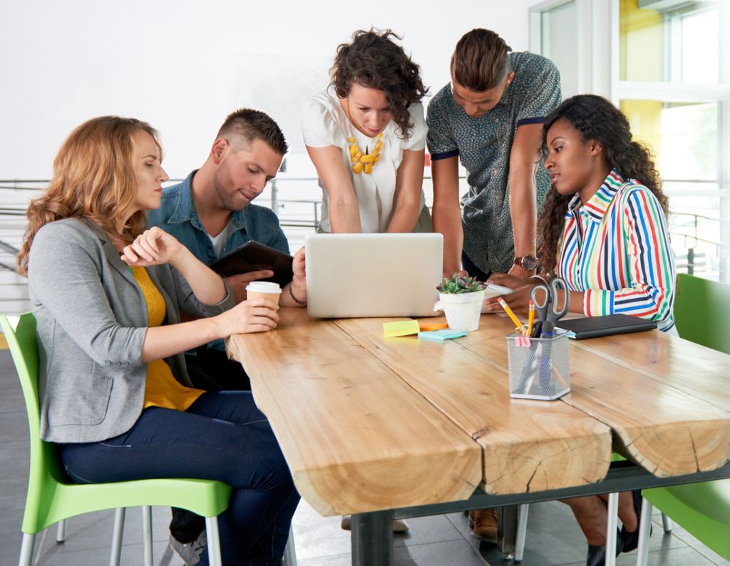 Millennial group around laptop